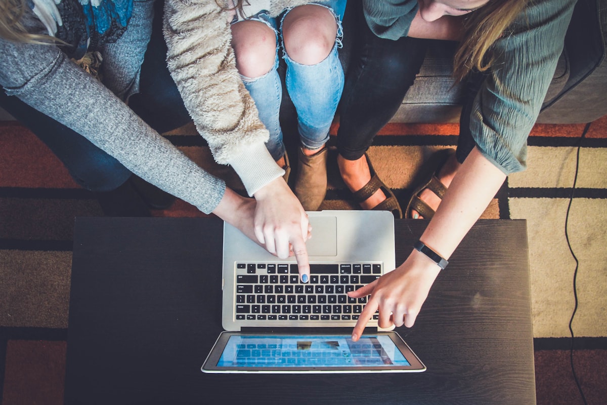 Dos personas dándose la mano sobre una mesa de trabajo